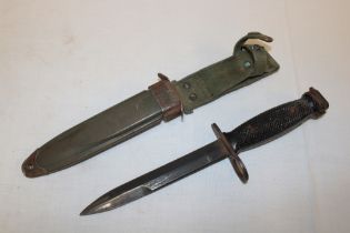 A United States M7 Vietnam era bayonet in composition scabbard marked "US M8A1 PWH"