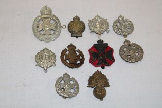 Ten various military cap badges including the Rifle Brigade, KRRC, 25th London Cyclists,