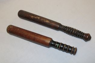 Two various turned wood police truncheons with painted handles,