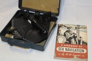 A navigational sextant by Ebbco in fitted case together with a handbook of sea navigation