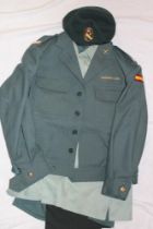 A Spanish Civil Guard uniform including beret, peaked cap, jacket,