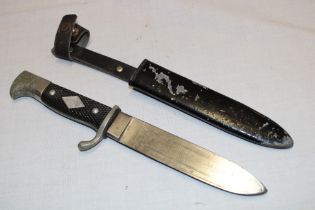 An unusual boy scout's dagger with single edged blade marked "Solingen" in painted steel scabbard