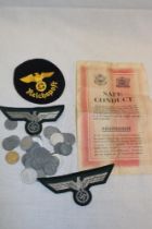 A Second War German soldier's safety conduct certificate, two unissued German Army eagle badges,