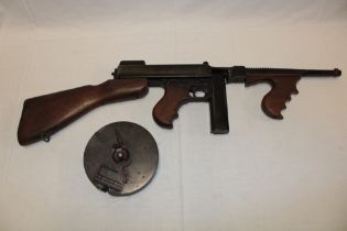 A good quality replica of an American Thompson machine gun model 1921 with stick and drum magazines