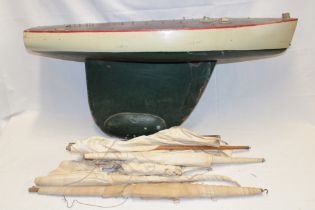 An old painted wood model pond yacht with weighted keel, mast and sails,