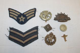 A selection of various military badges and insignia including Royal Flying Corps cap badge,