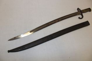 A 19th century French Chassepot bayonet with curved single-edged blade in steel scabbard