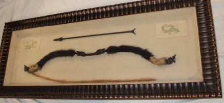 A copy of an antique Chinese bow and arrow originally made of bamboo,