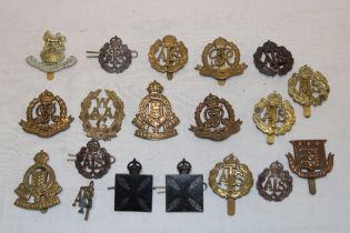 A selection of various military cap badges including two Army Chaplain's Department badges, ATS,