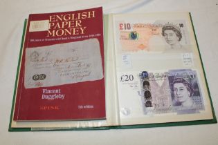 An album containing a collection of British bank notes including blue £1 notes signed Peppiatt,