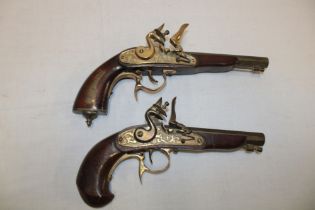 Two various replica flint-lock pistols with brass barrels and mounts