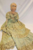 A 1930's cloth covered doll with porcelain lower limbs,