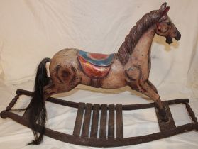 A carved and painted wood traditional-style rocking horse on rocking cradle,