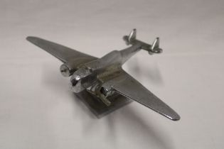 A chromium-plated desk model of a twin engine aircraft