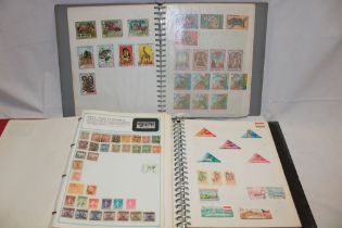 Three albums containing a mixed selection of World stamps