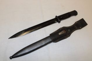 A German K98 Mauser bayonet with 10" blackened steel blade marked "44 fnj" in steel scabbard with