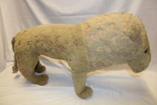 An old plush covered straw filled standing lion/bear 32" long overall