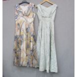 Two mid 20th Century evening dresses, grey and mustard chiffon pattern and ice blue self pattern