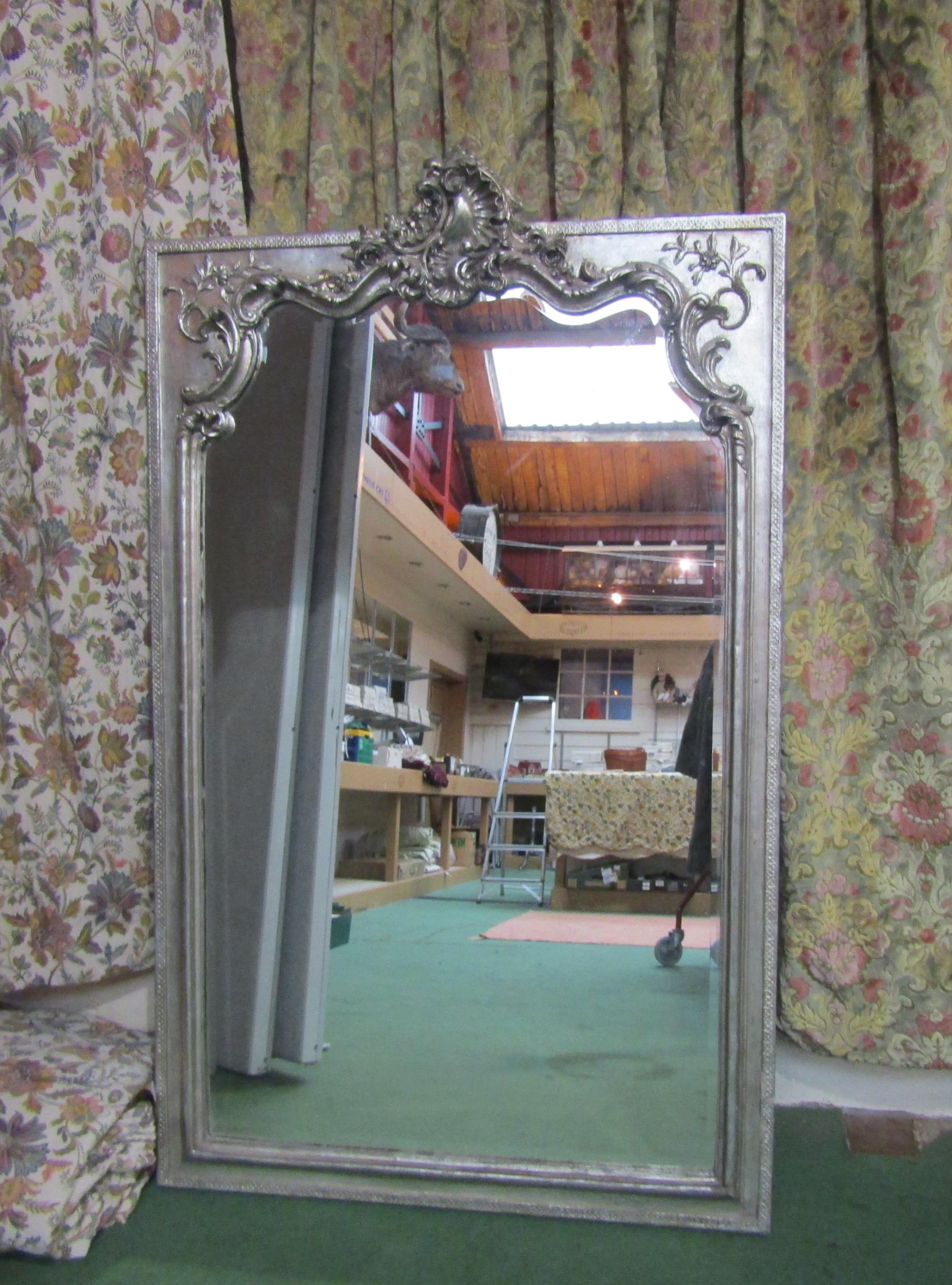 A shabby chic style silver painted wall mirror, foliate design
