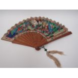 A mid/late 19th Centruy Mandarin asymmetric fan with sandalwood sticks, the guards being heavily