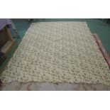 A cream ground cotton quilted scalloped edge bedspread with an olive, yellow and teal foliate