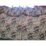 A pair of glazed chintz curtains, cream ground with puce and green blousey floral pattern, a