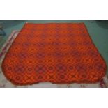 A vintage all wool tapestry bedspread, in orange and brown tones, made in Wales