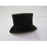 A vintage tan leather top hat box containing a black silk top hat, hat box a/f