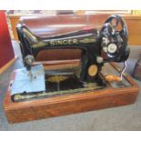 A Singer manual sewing machine, cased with key
