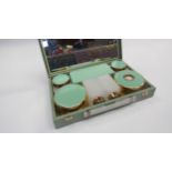 A small 1950's vanity case with contents, celadon colour detail, together with a pink lace parasol