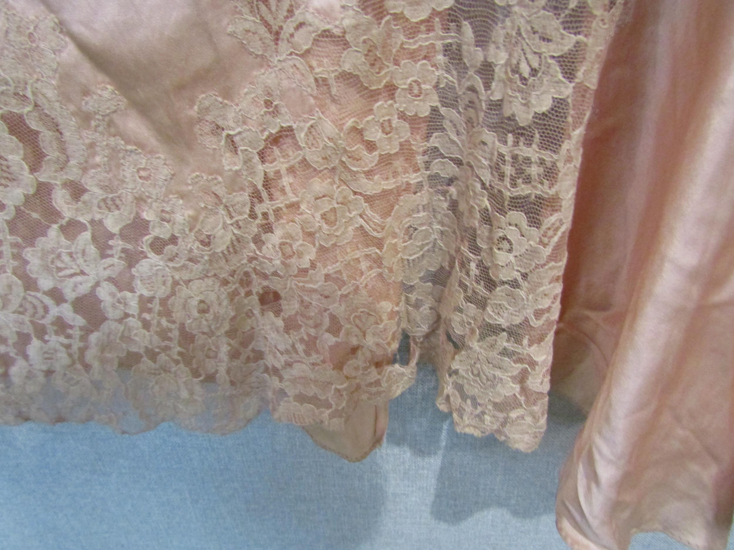 A 1930's/40's peach silk dressing gown with toning lace detail, a/f in some areas to the lace, and a - Image 2 of 3