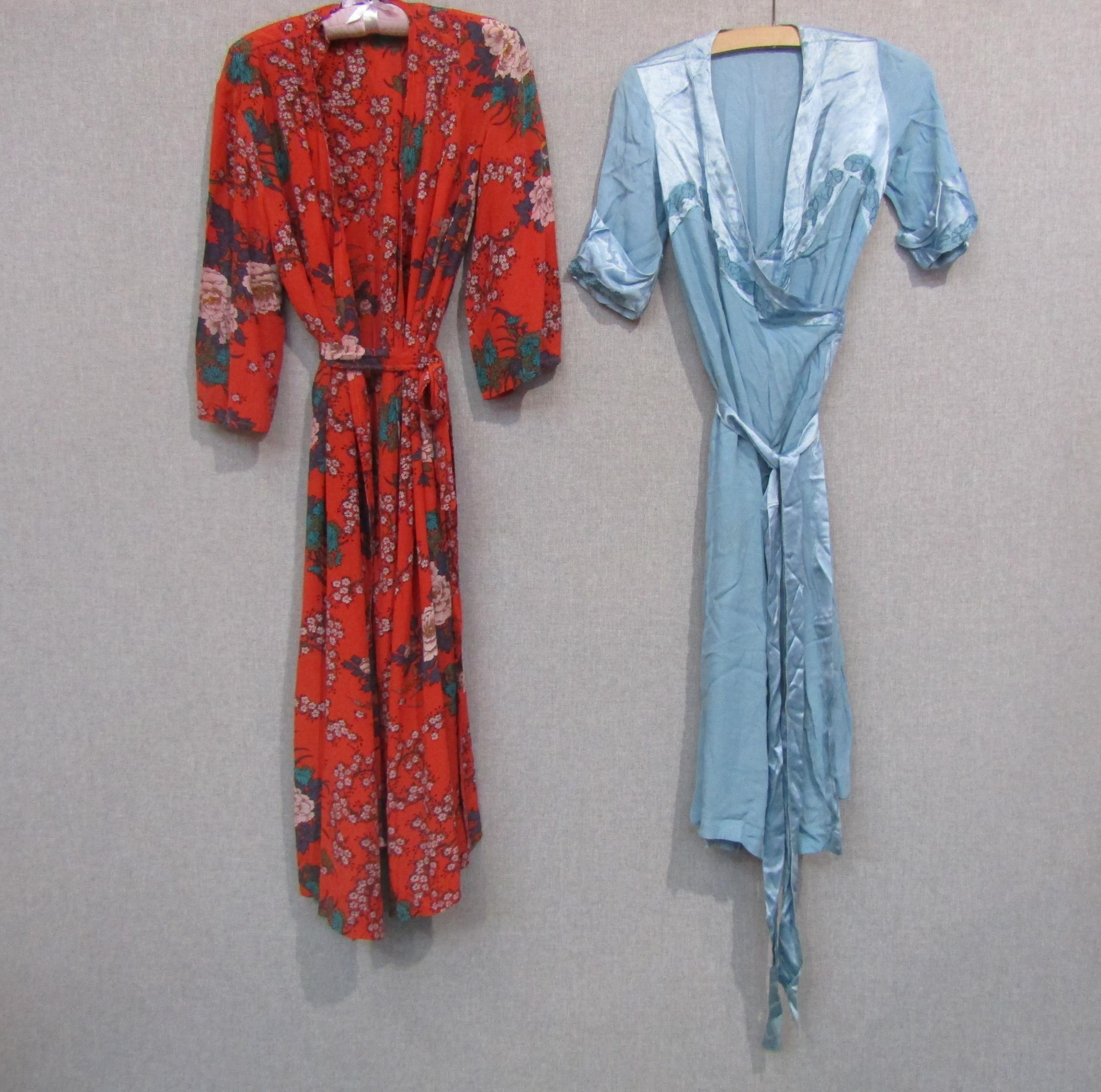 A vintage red floral silk lady's dressing gown and a plain mid blue silk crepe dressing gown wih