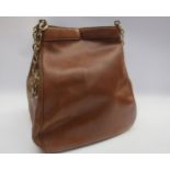 CHRISTIAN DIOR: A vintage tan leather shoulder bag, concertina action, yellow metal chain shoulder