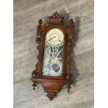 An Ansonia Clock Co. wall-hanging clock with compensation pendulum, 74cm tall x 30cm wide