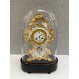 A 19th Century Valery of Paris ceramic clock enriched with gilt and floral sprays, enamel face a/