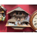A chalet design cuckoo clock, with three weights