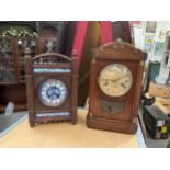 An early 20th Century walnut mantel clock with blue and white floral design ceramic dial and