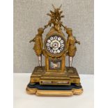 A late 19th Century French figural ormolu mantel clock, Sevres style face and panels, surmounted