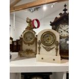 Two alabaster mantel clocks, one surmounted by cherub