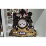 A 19th Century French spelter and ormolu figural clock with painted ceramic panel to base