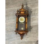 A circa 1900 Vienna style wall clock with decorative painted columns and panels, with pendulum