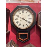 An American Waterbury Clock Co. USA drop dial wall clock, Roman dial, with pendulum