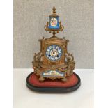 A 19th Century French ormolu mantel clock with hand painted ceramic face and panels, 36cm tall