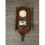 A late 19th Century mahogany wall-hanging clock with compensatory pendulum, new face, also two keys