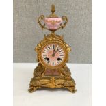 A 19th Century French mantel timepiece, ormolu case with pink and white porcelain face and lower