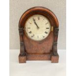 A 19th Century walnut cased mantel clock with arched top, carved sides, Roman numerated dial,
