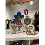 Four early 20th Century ceramic clocks, one of easel form