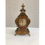 A 19th Century balloon form mantel clock, burr wood applied with scrolled ormolu front, ebonised