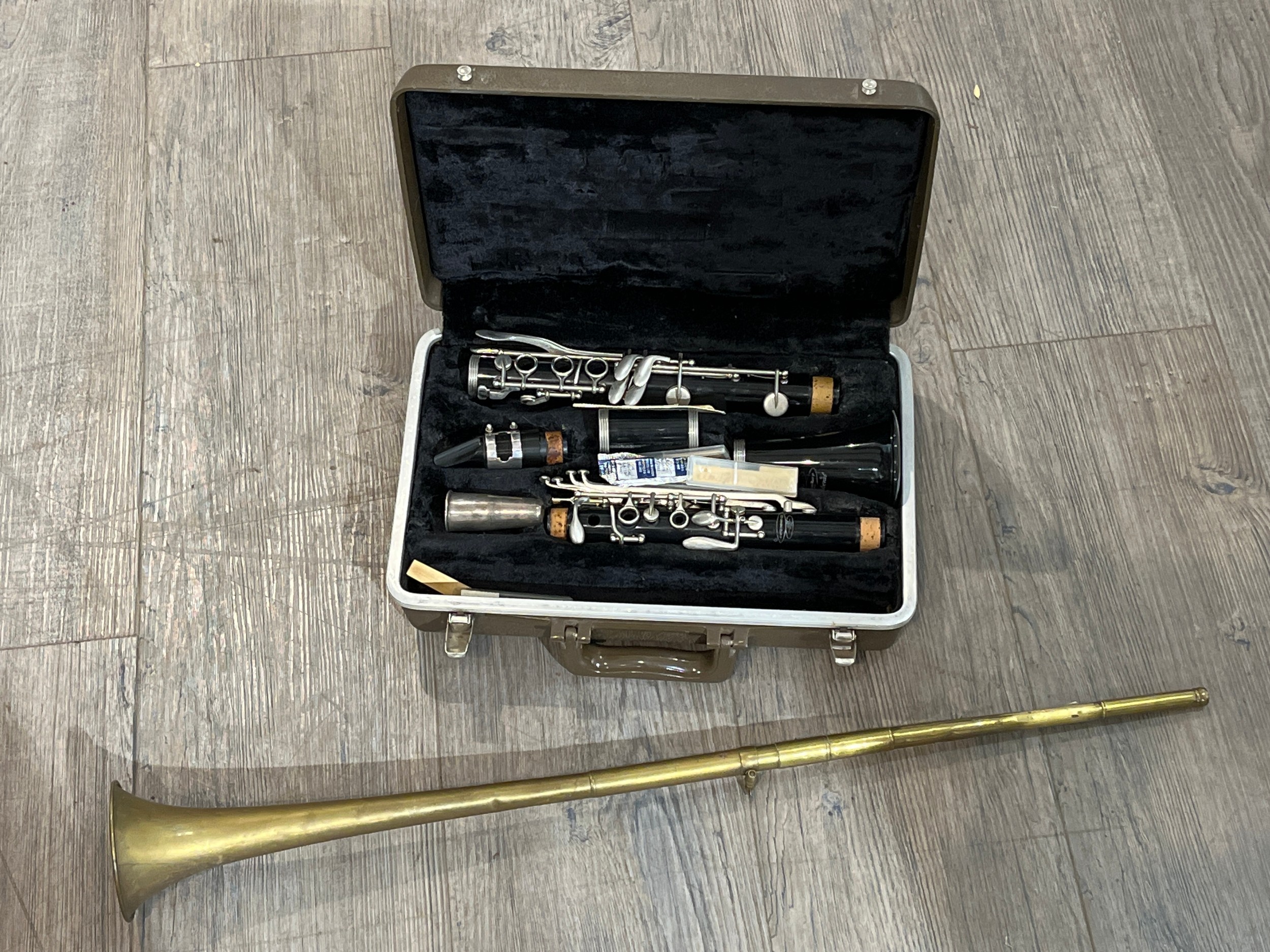 A Buescher clarinet, cased, together with a post horn (2)