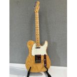 A Fender American Series Telecaster in natural ash, serial number Z1032582, maple neck, Fender